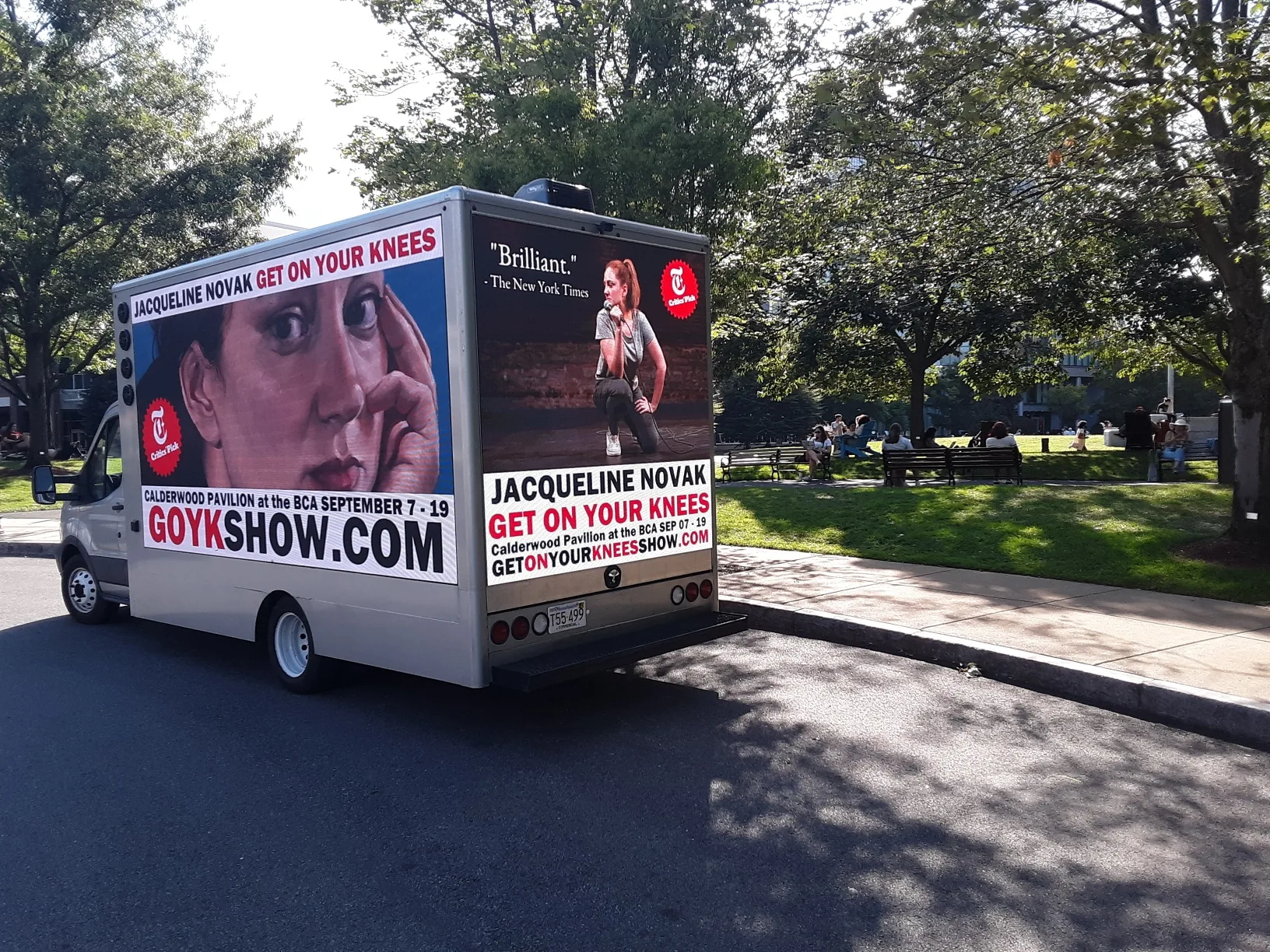 Billboard truck beside a park displaying Jacqueline Novak show artwork for a Calderwood Pavilion at the BCA engagement in Boston