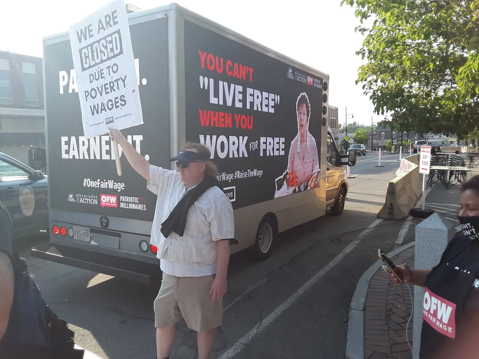 Billboard truck displaying labor advocacy messages about wages and working conditions