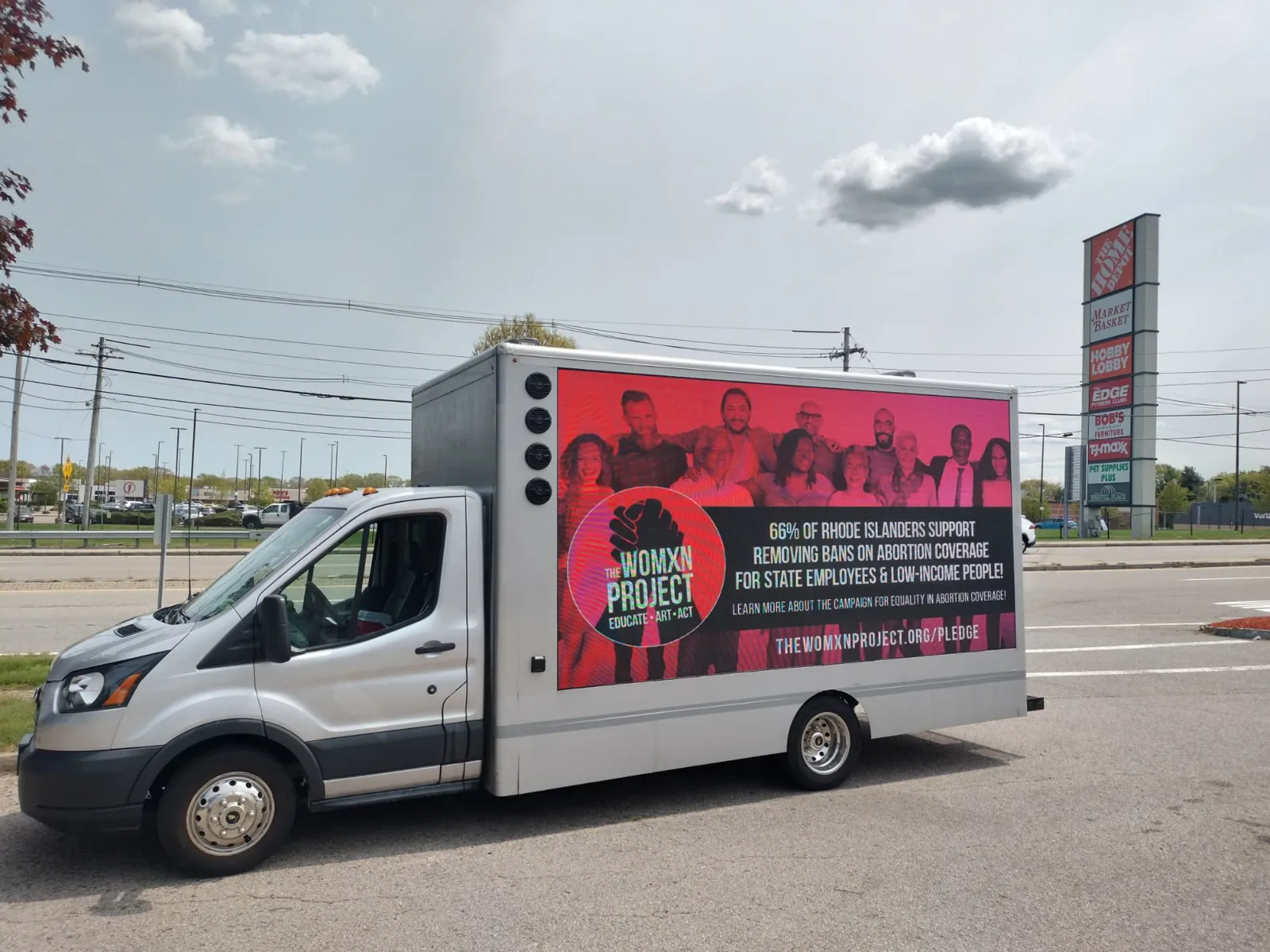 LED billboard truck displaying The Womxn Project abortion-coverage campaign message in Rhode Island