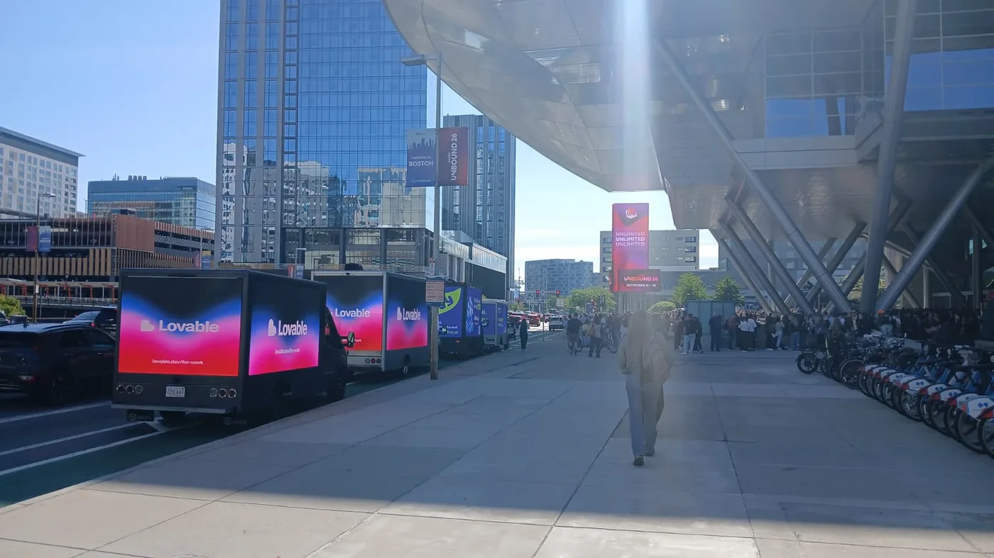 Lovable and Ahoy mobile LED billboard trucks advertising simultaneously outside UNBOUND 2026 in Boston