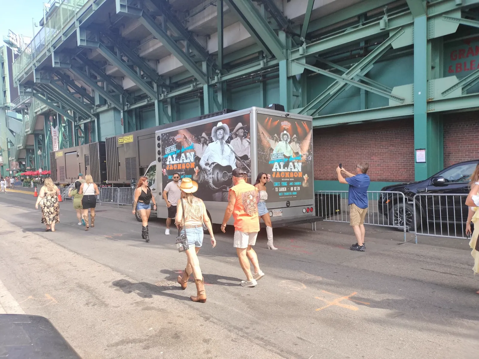 LED billboard truck promoting Alan Jackson Last Call tour concert outside TD Garden Boston with fans taking photos