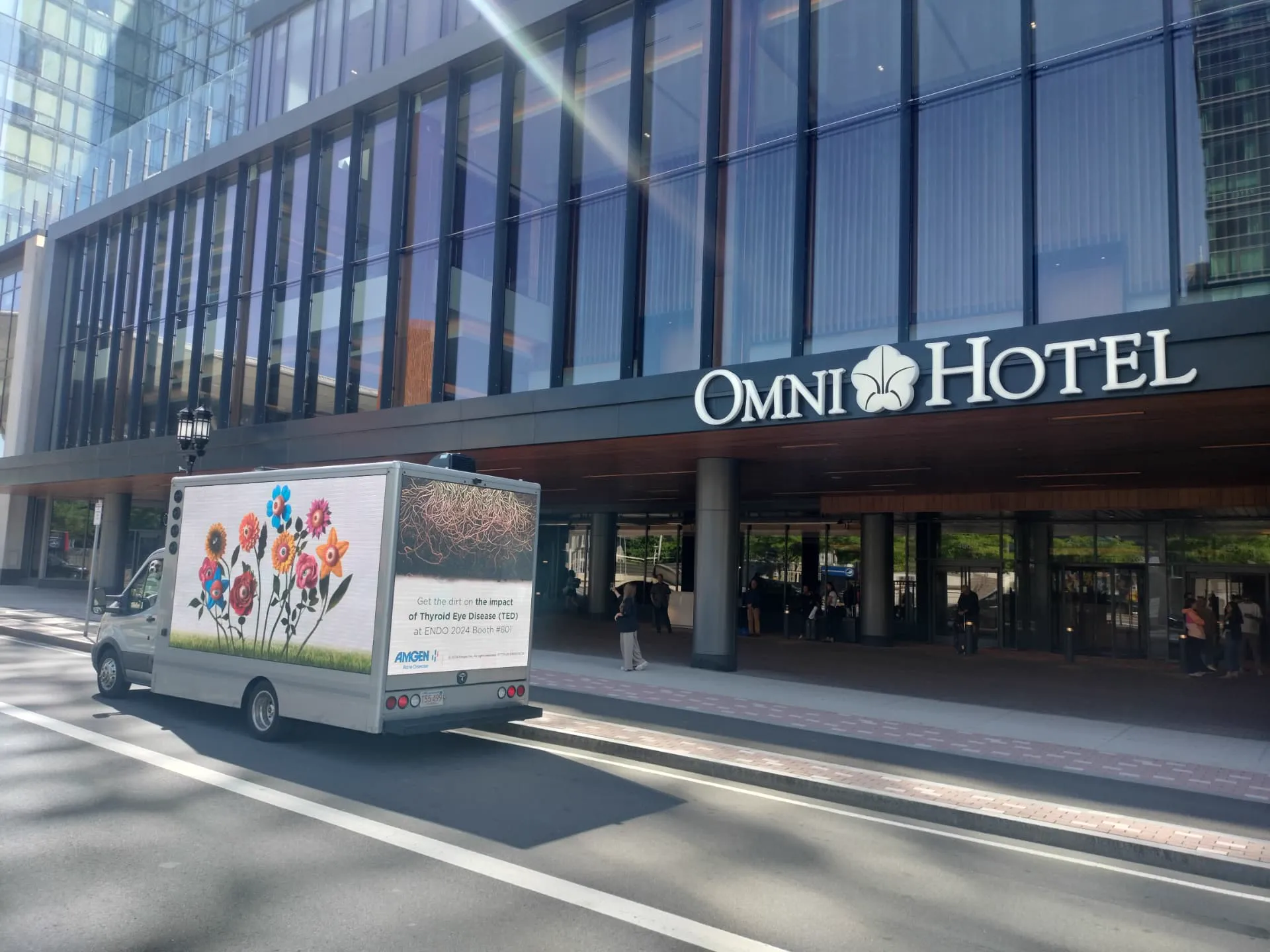 Amgen mobile LED billboard truck promoting Thyroid Eye Disease awareness outside Omni Boston Hotel at the Seaport during ENDO 2024