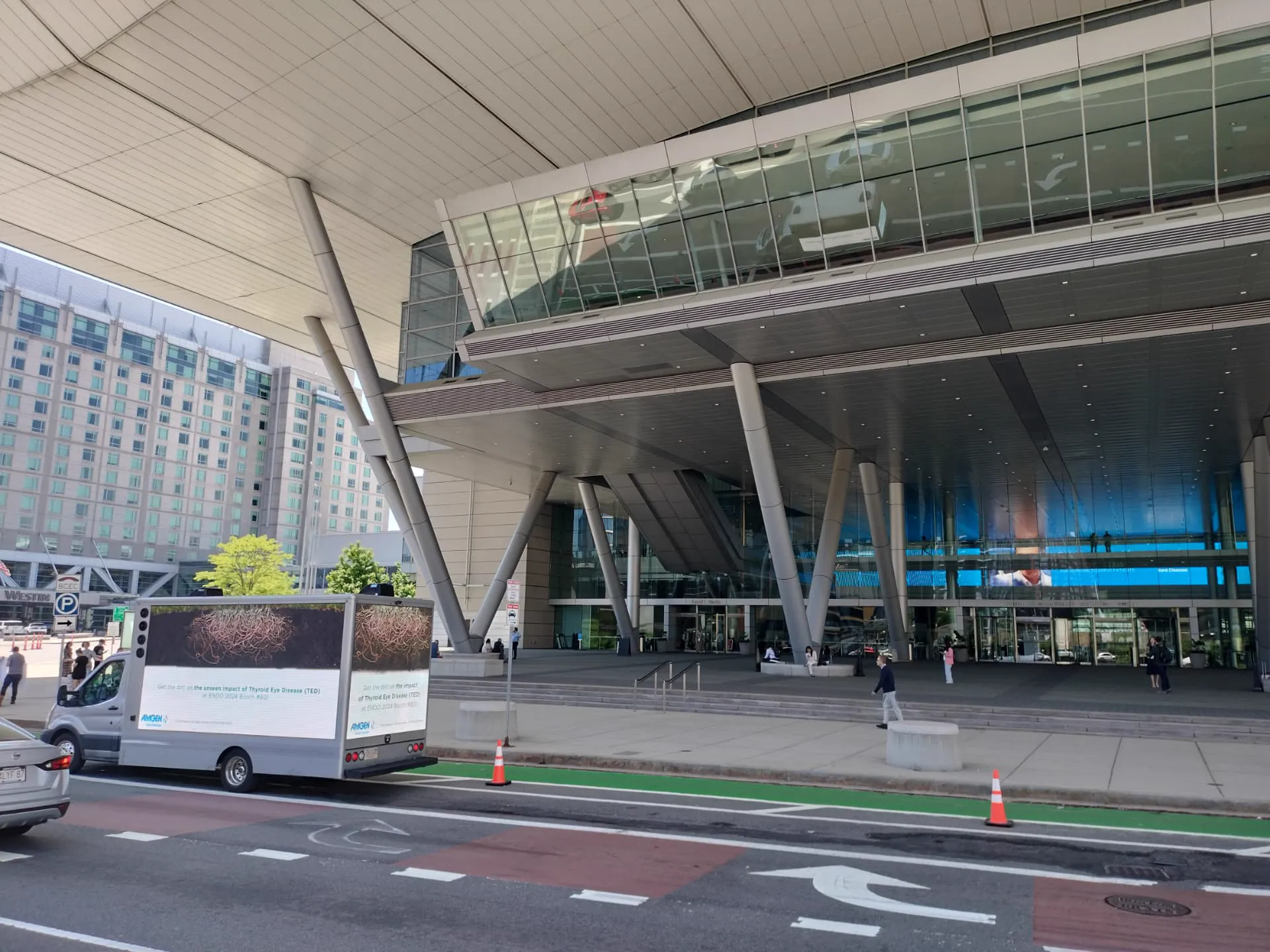 Amgen mobile billboard truck advertising Thyroid Eye Disease awareness along Summer Street at the Boston Convention and Exhibition Center