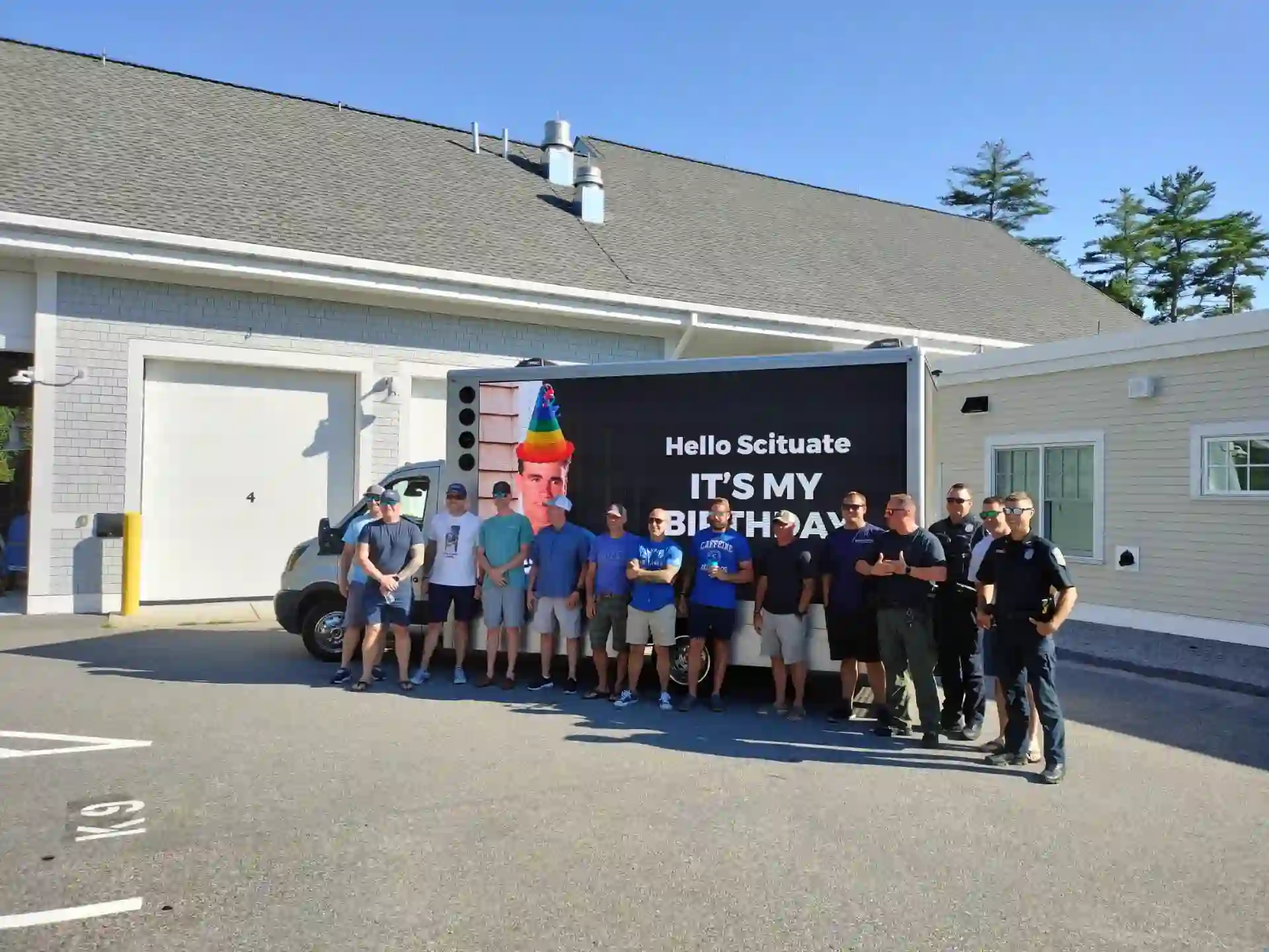 LED billboard truck displaying a birthday surprise message in Scituate Massachusetts with the birthday group posing in front