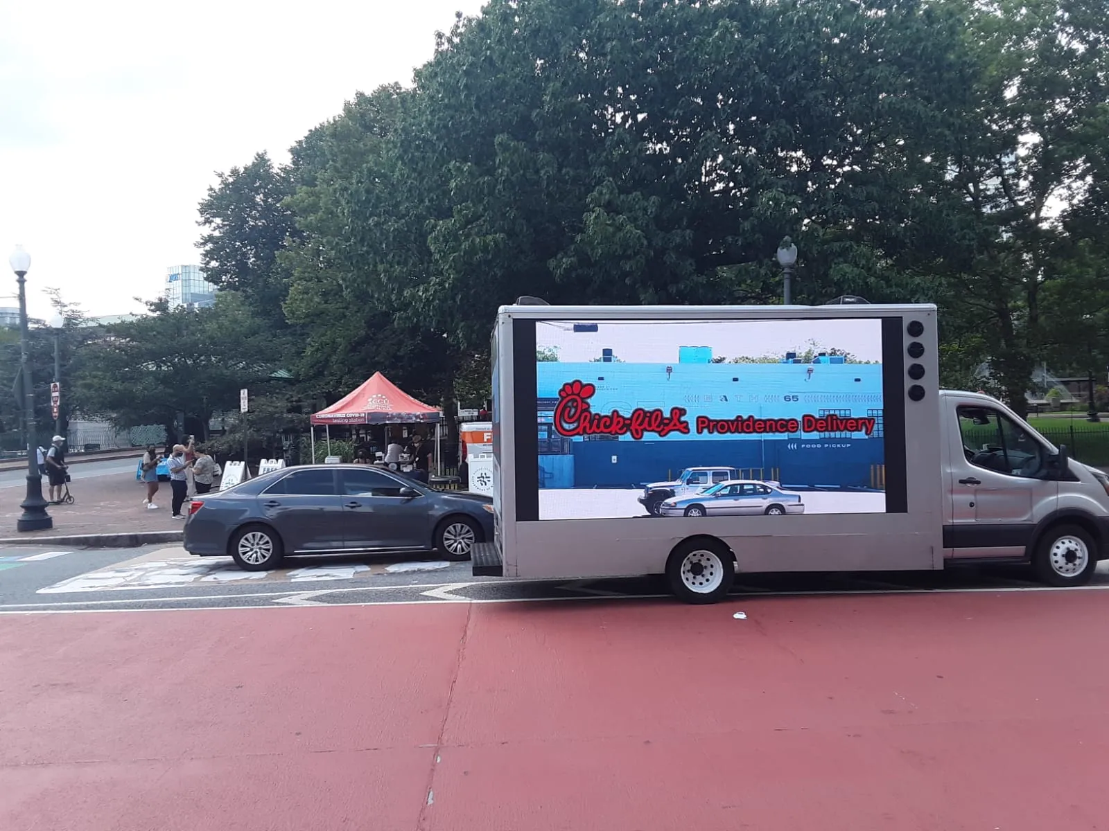 Mobile LED billboard truck playing Chick-fil-A Providence Delivery video showing the restaurant building