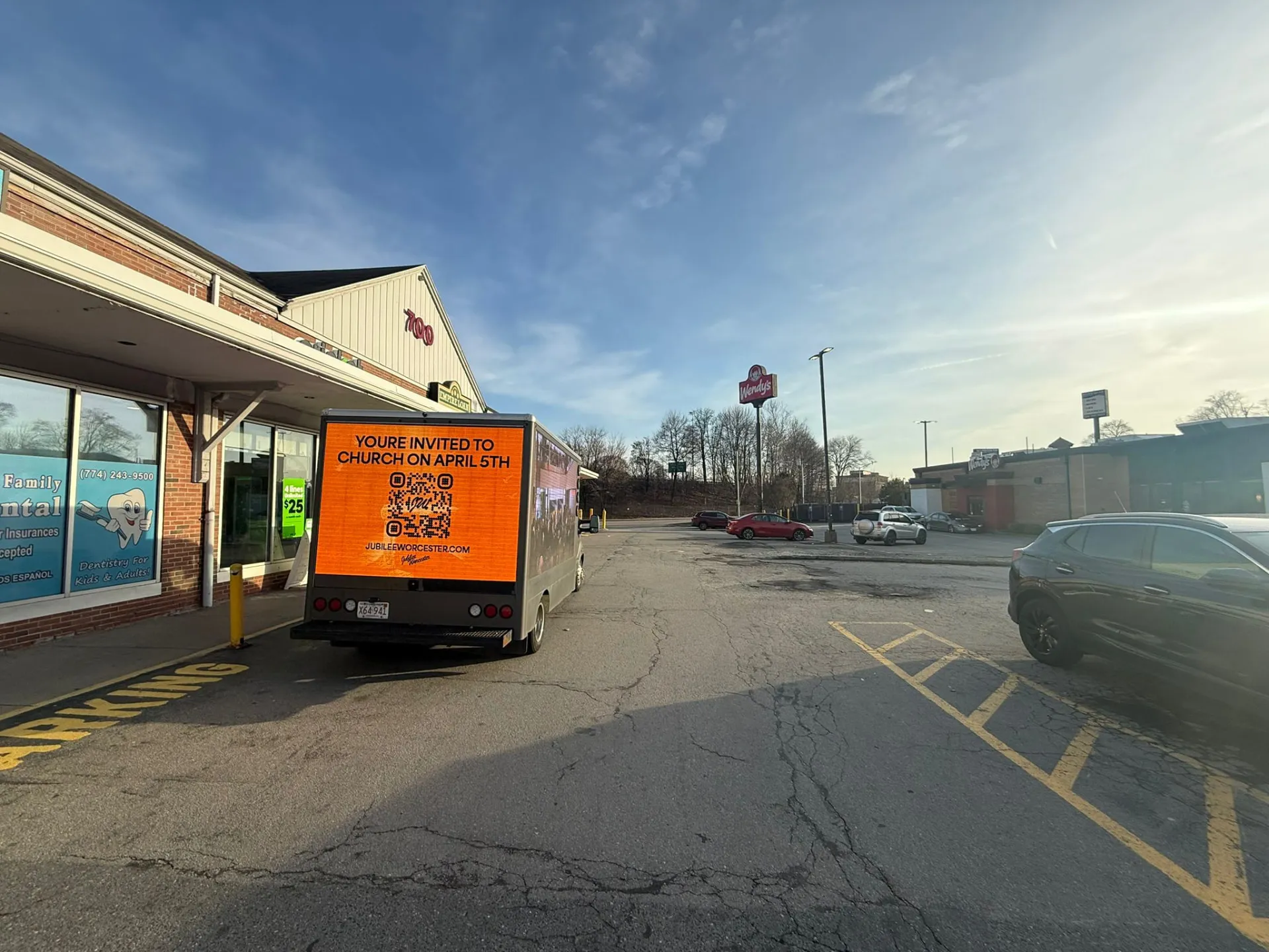 Church service invitation on a mobile LED billboard truck near restaurants and shops in Worcester Massachusetts