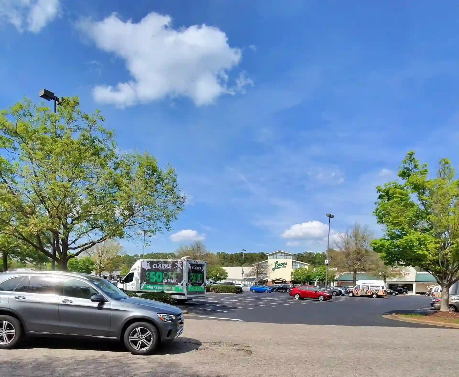 Clark's Pest Control LED billboard truck advertising $50 off any service outside Lowe's Foods in Raleigh NC