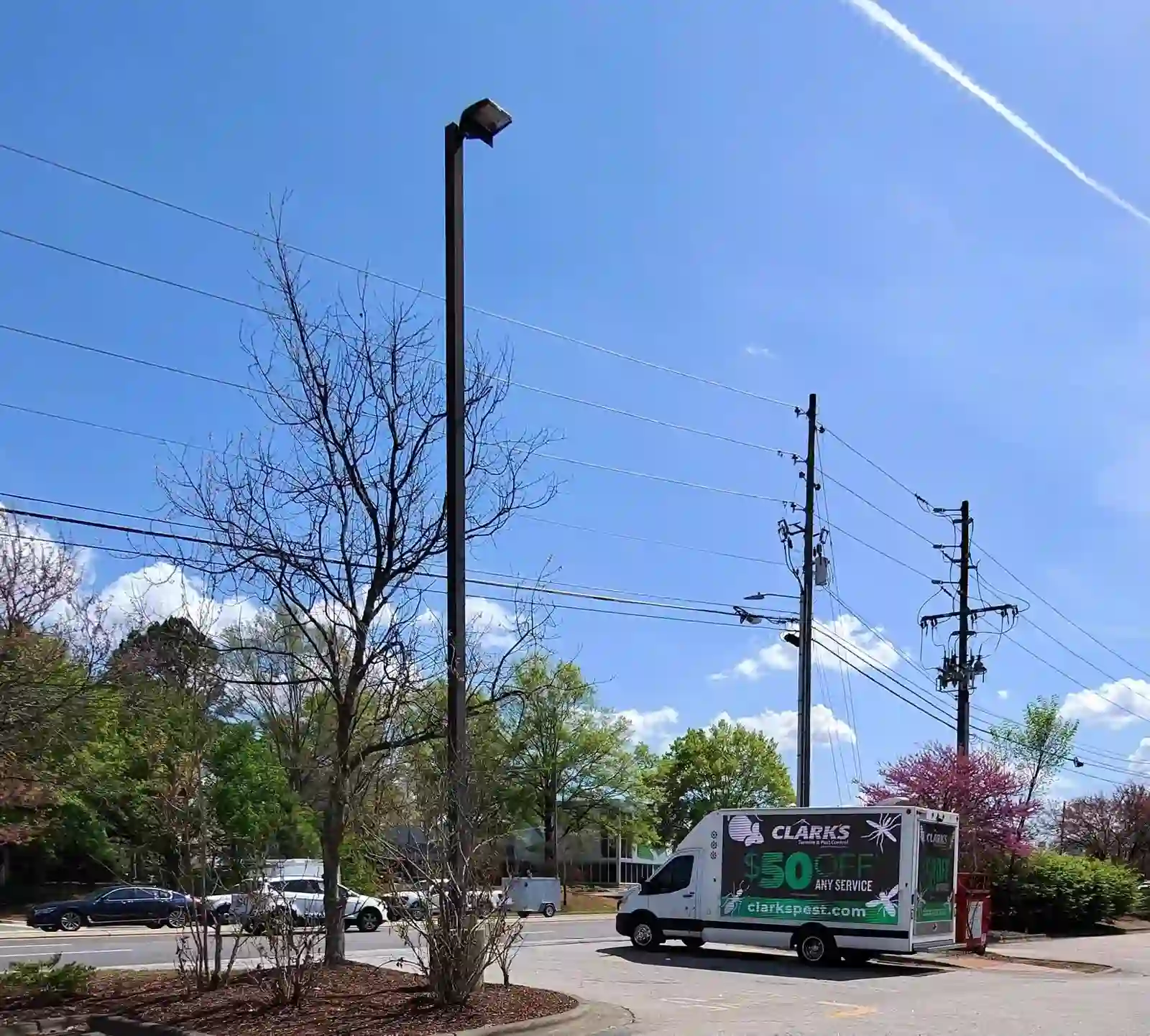 Clark's Pest Control LED billboard truck on Glenwood Avenue near Crabtree Valley Mall in Raleigh