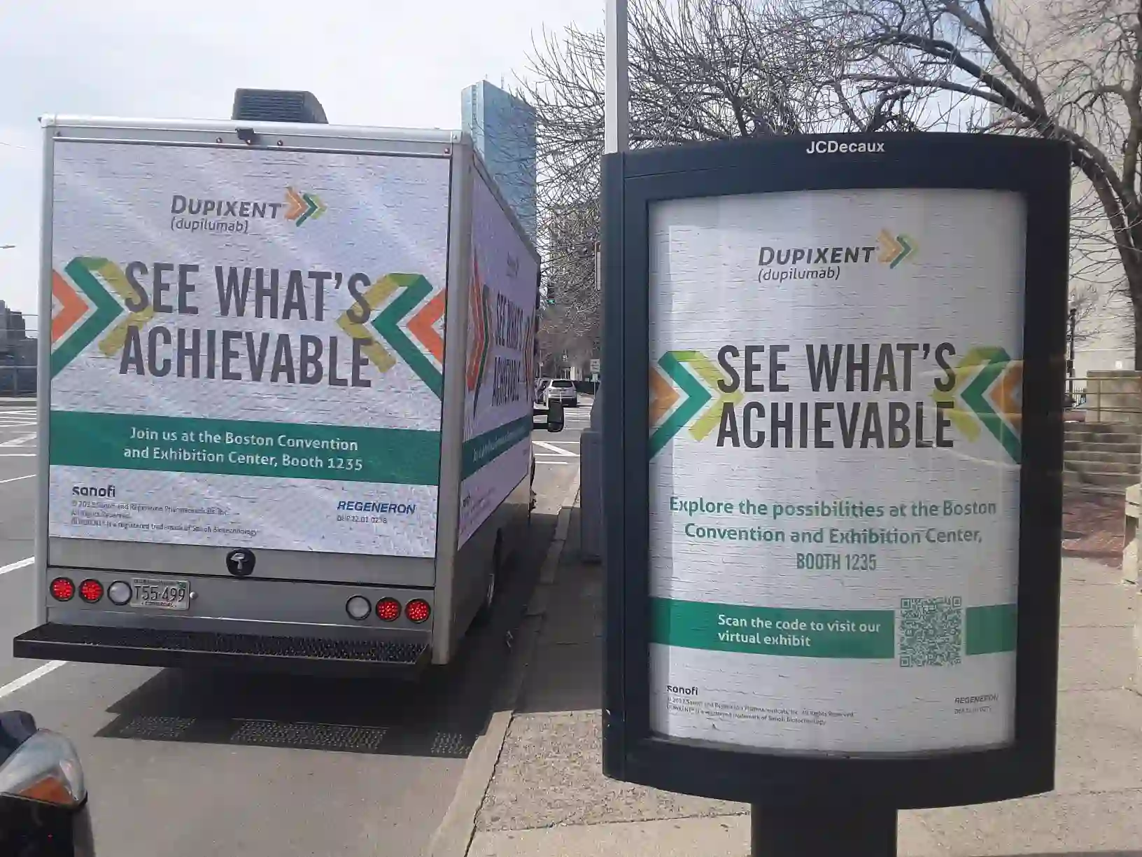 Dupixent LED billboard truck parked beside a matching JCDecaux street ad near the Boston Convention and Exhibition Center
