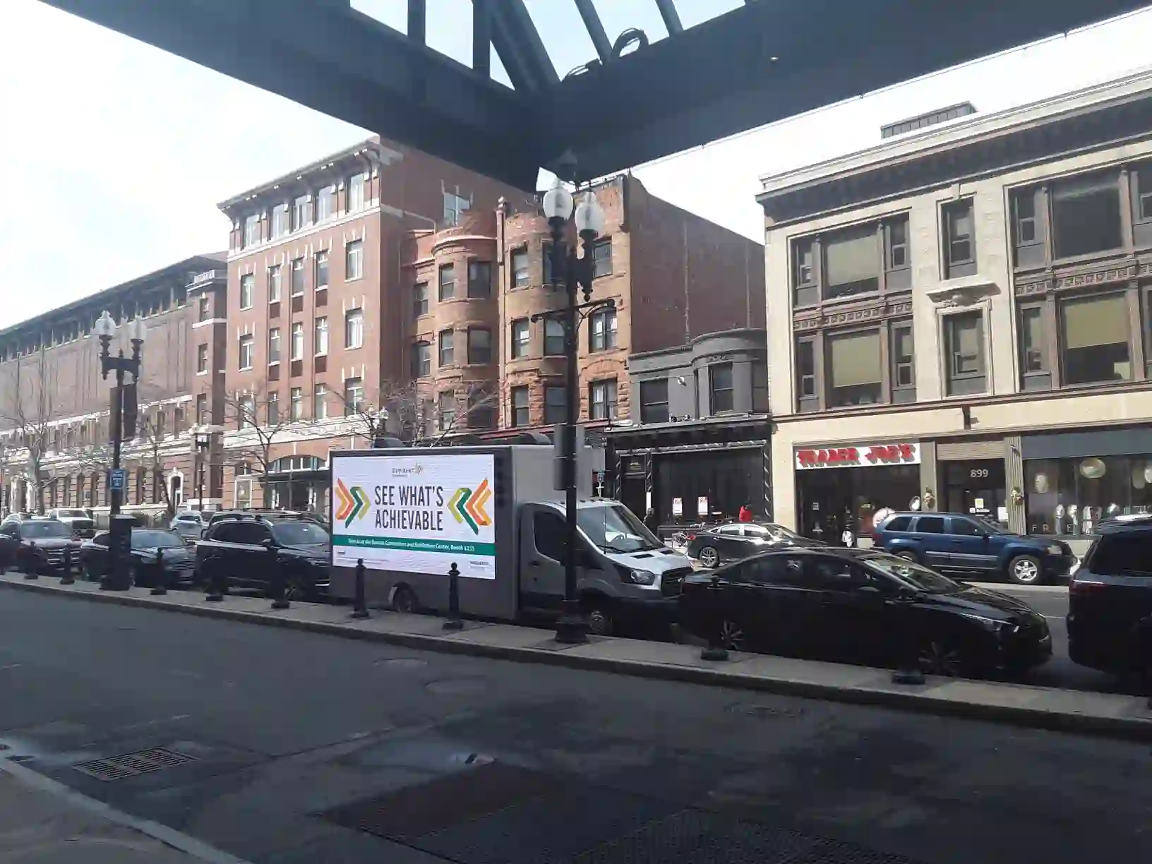 Dupixent LED billboard truck on Boylston Street in Back Bay Boston near shops and restaurants