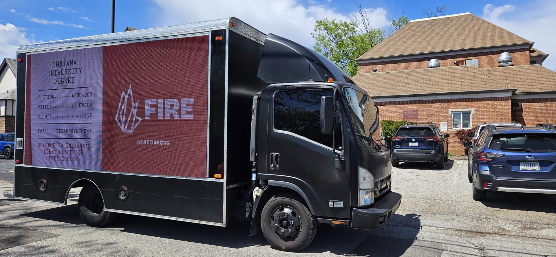 LED billboard truck displaying FIRE's Indiana University Degree receipt-style creative in Bloomington, Indiana