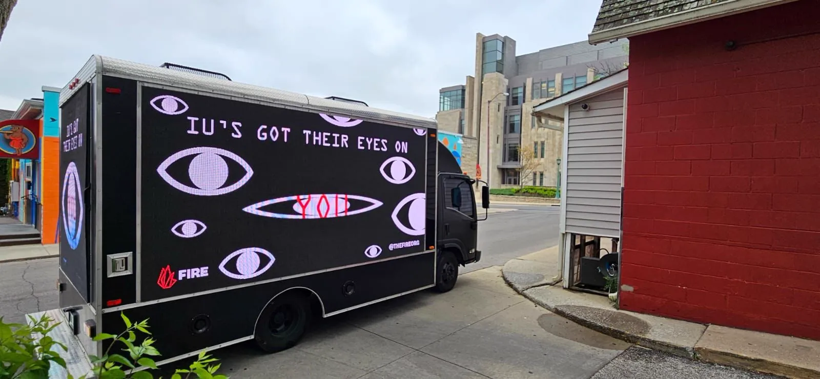 FIRE LED billboard truck reading IU's Got Their Eyes on You on a street near Indiana University in Bloomington