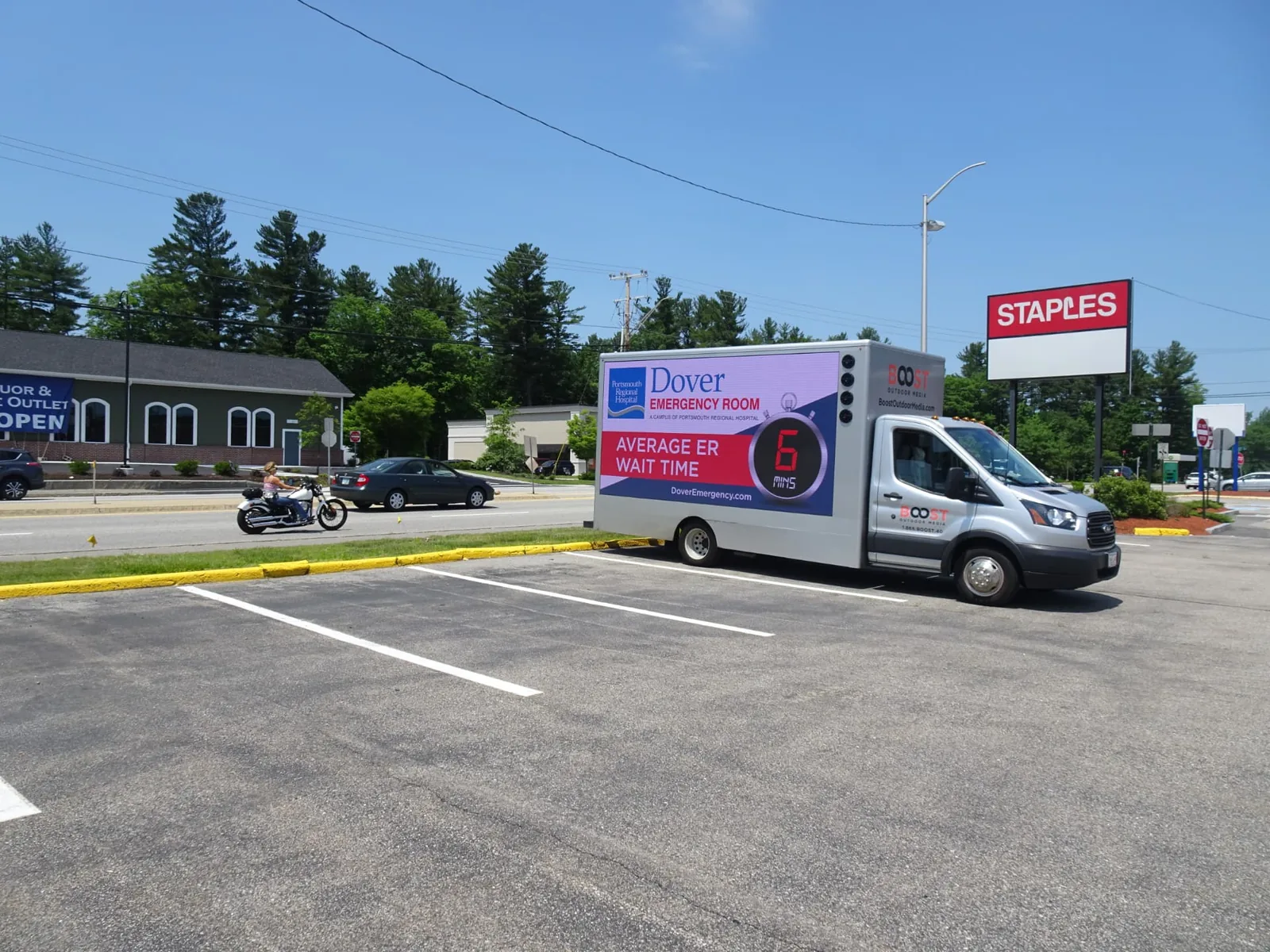 Boost Outdoor Media LED truck advertising Dover Emergency Room average ER wait time of 6 minutes outside a retail plaza in Dover, New Hampshire