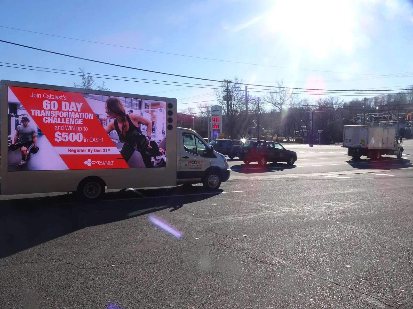 LED billboard truck with an ad at a busy city intersection — the kind of high-traffic corner Chicago's Loop and River North are known for