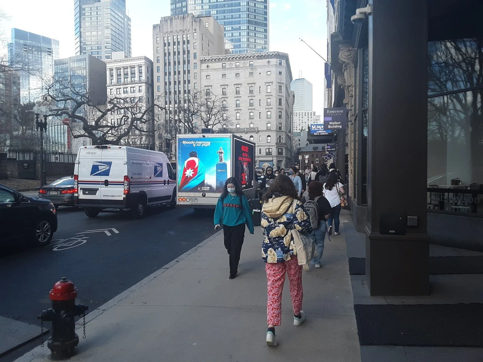 Boost Outdoor Media LED billboard truck driving through downtown traffic — the dedicated-truck setup we run for mobile billboard campaigns in Chicago