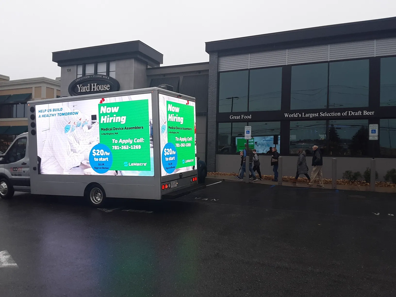 LED billboard truck advertising a Now Hiring campaign for medical device assemblers at $20 per hour in Burlington, MA