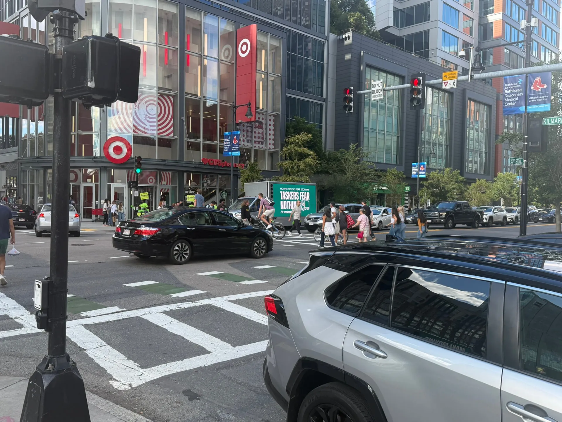 LED advertising truck with TaskRabbit campaign visible among pedestrians and traffic on Boylston Street near Fenway in Boston