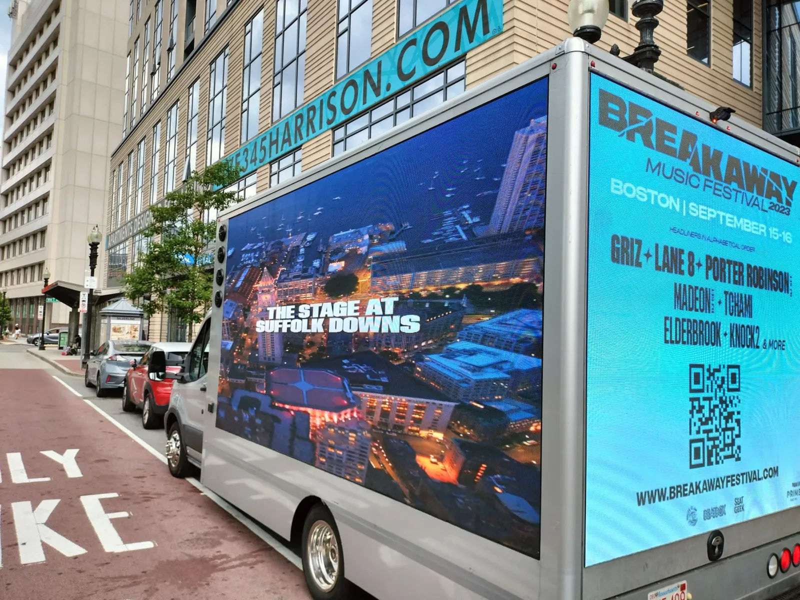 Mobile LED billboard truck promoting a Boston music festival lineup on a downtown street
