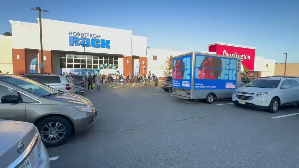 Nordstrom Rack Ramsey grand-opening crowd and Boost Outdoor Media LED billboard truck outside the store