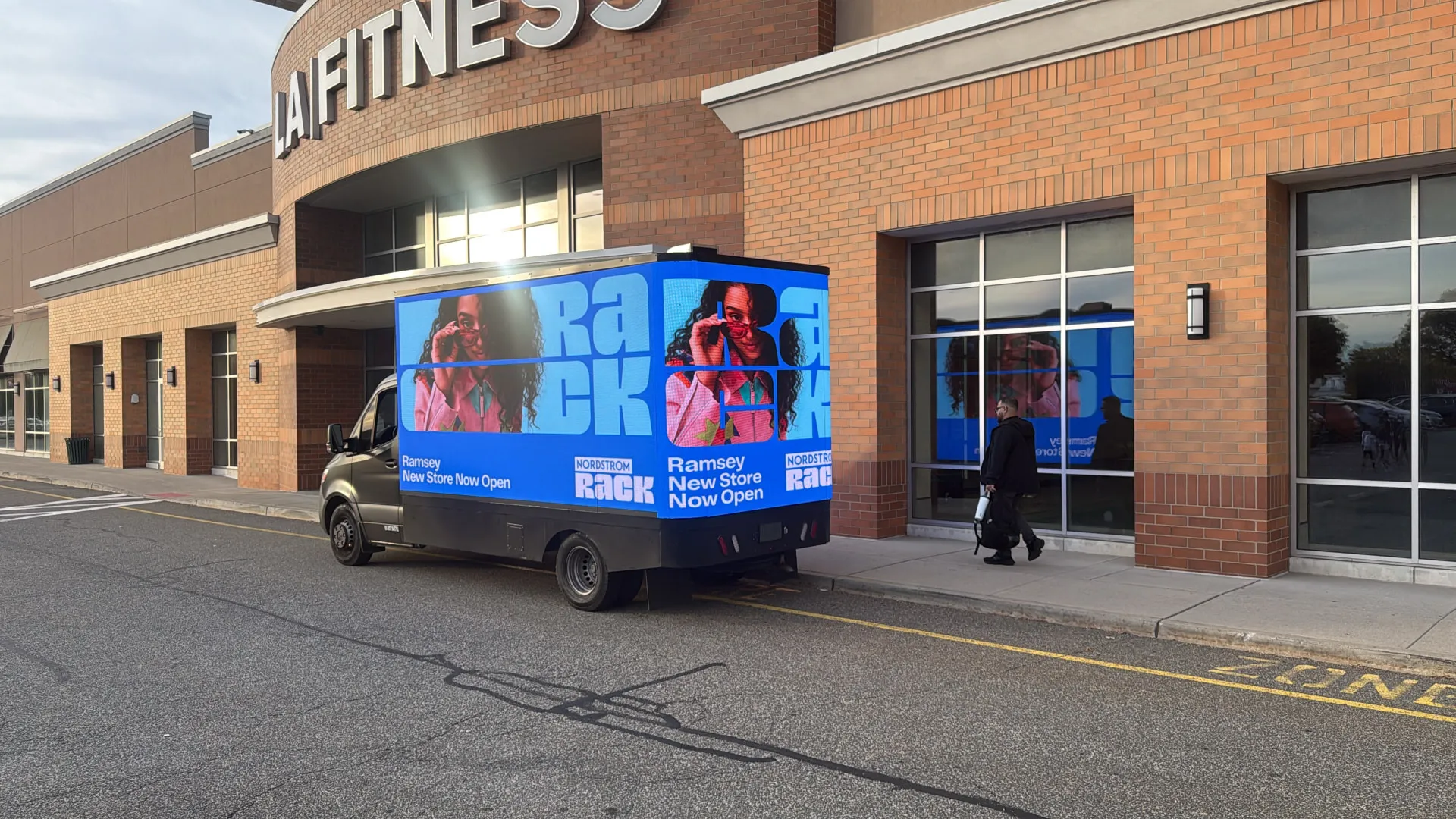 Nordstrom Rack branded LED billboard truck beside a fitness storefront during Boost Outdoor Media’s retail grand-opening campaign