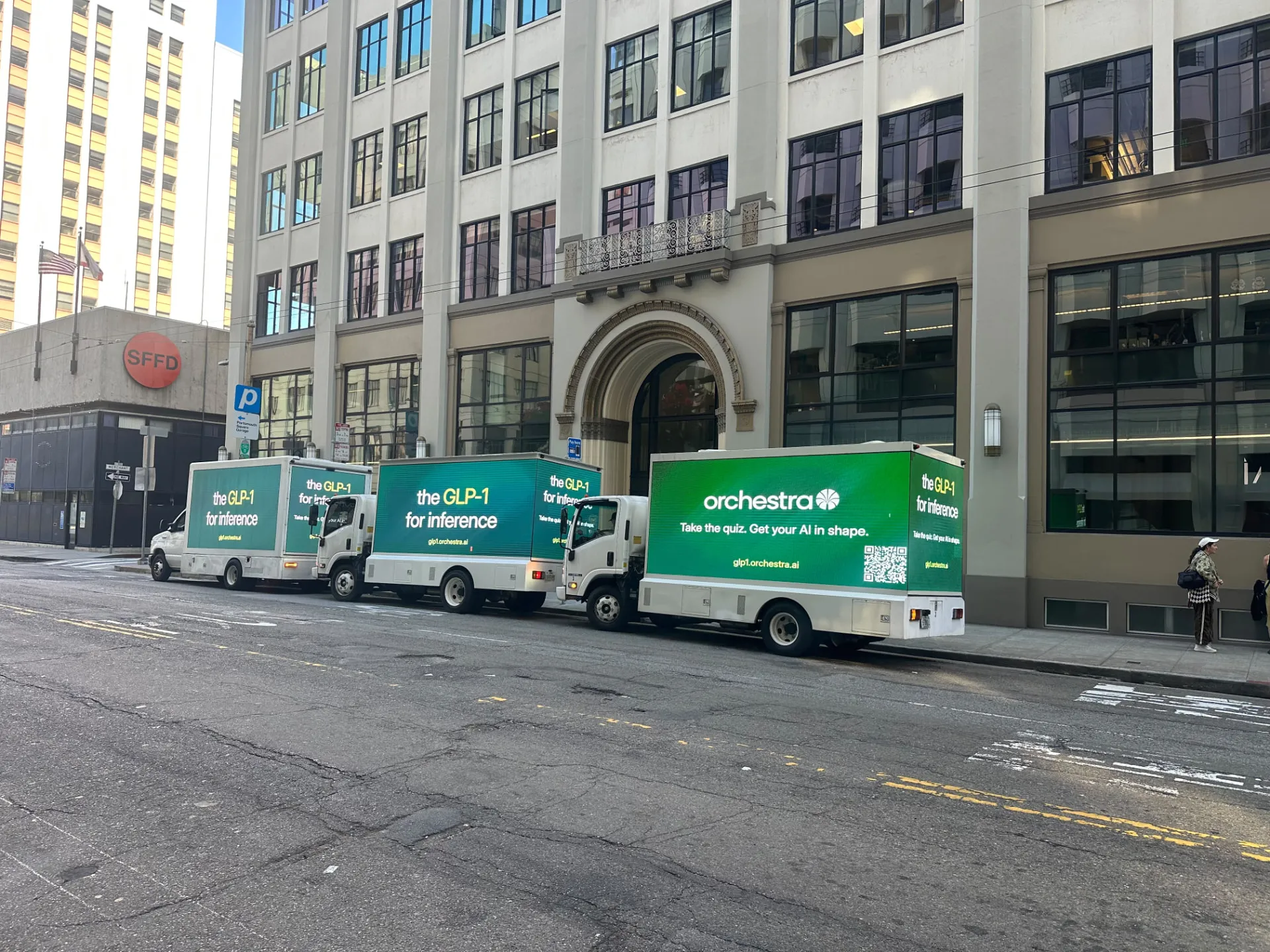 Three Orchestra AI LED billboard trucks displaying green campaign creative together on a San Francisco street