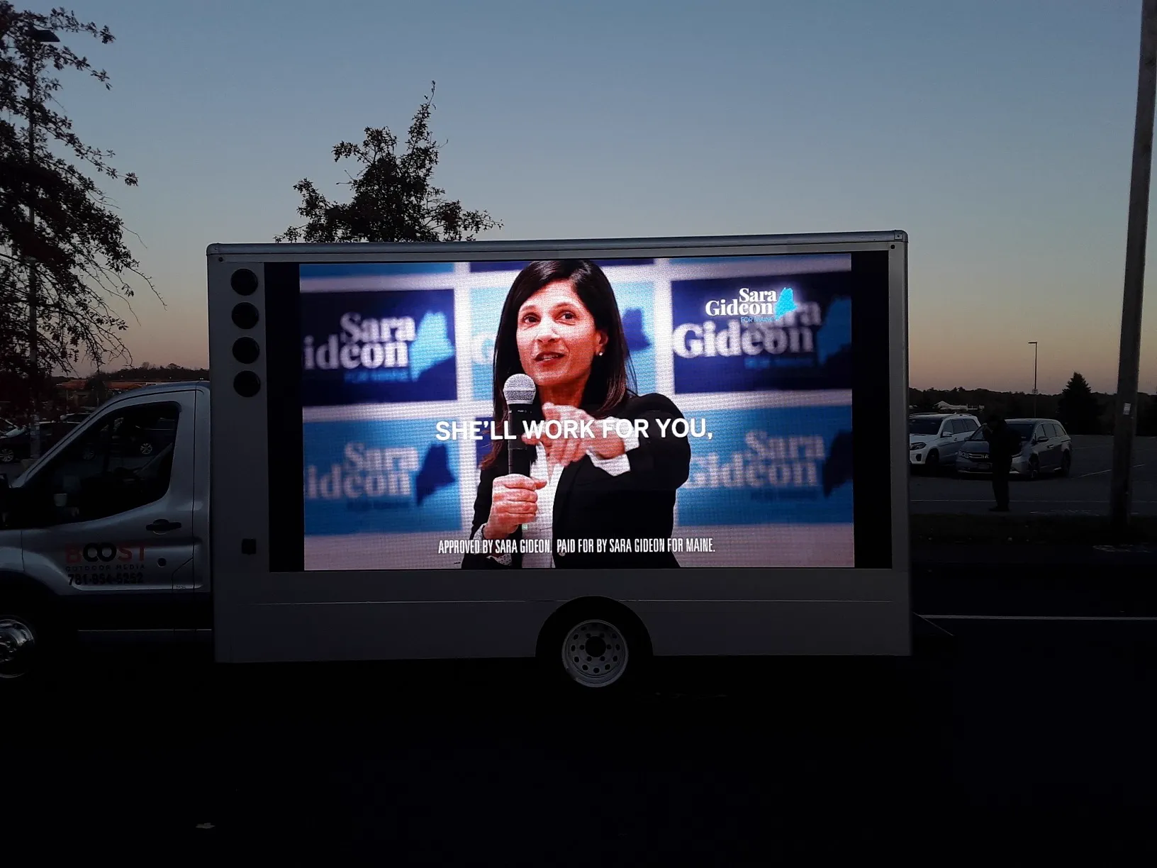 LED billboard truck running a Maine Senate campaign video advertisement at dusk