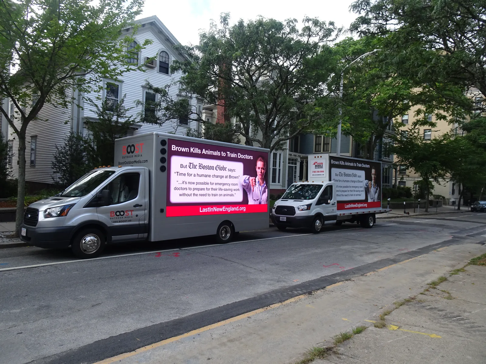 Two LED billboard trucks running together as a convoy for a political advocacy campaign downtown