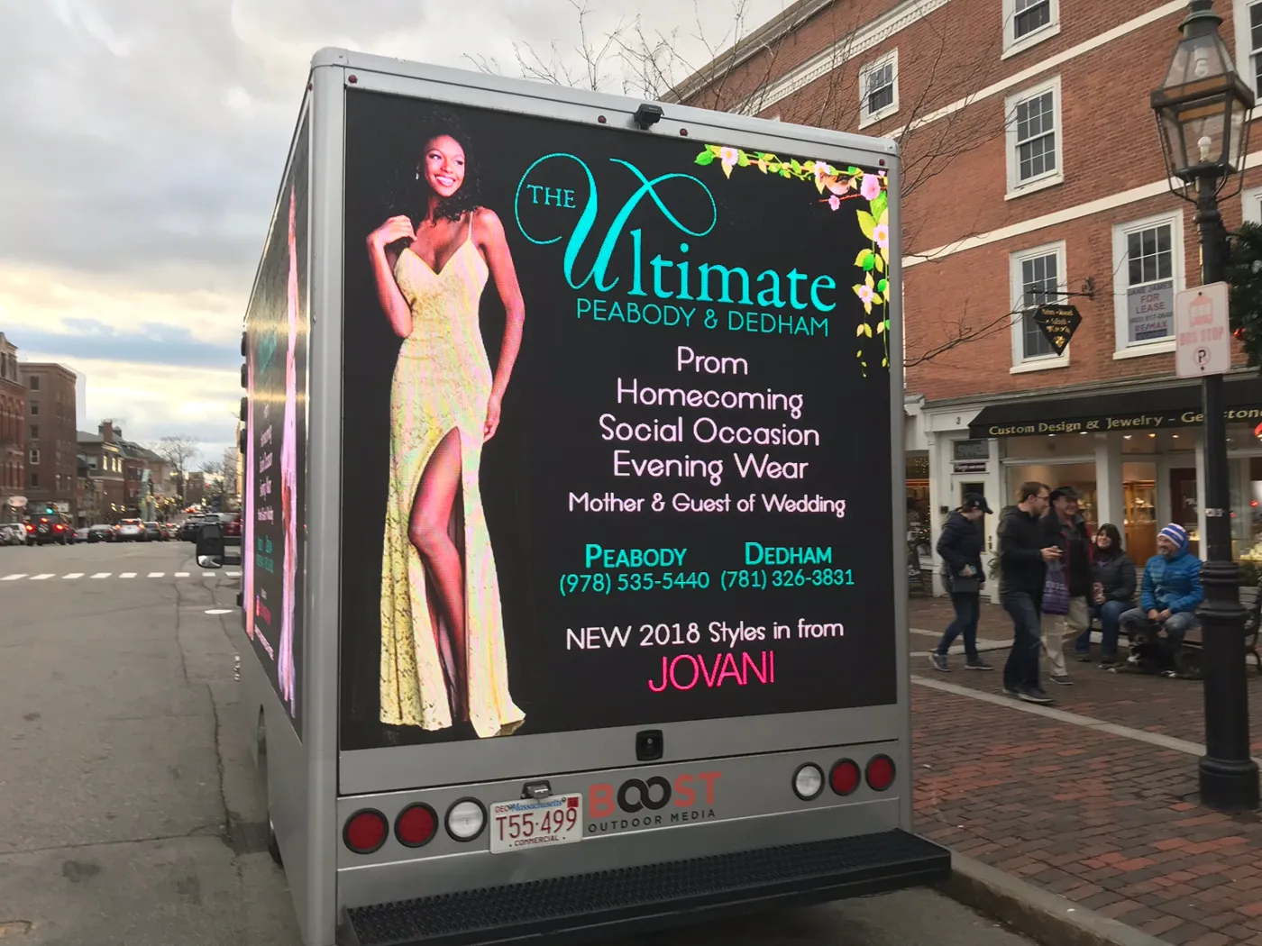 The Ultimate LED truck rear screen showing prom, homecoming, and evening wear categories with Peabody and Dedham phone numbers