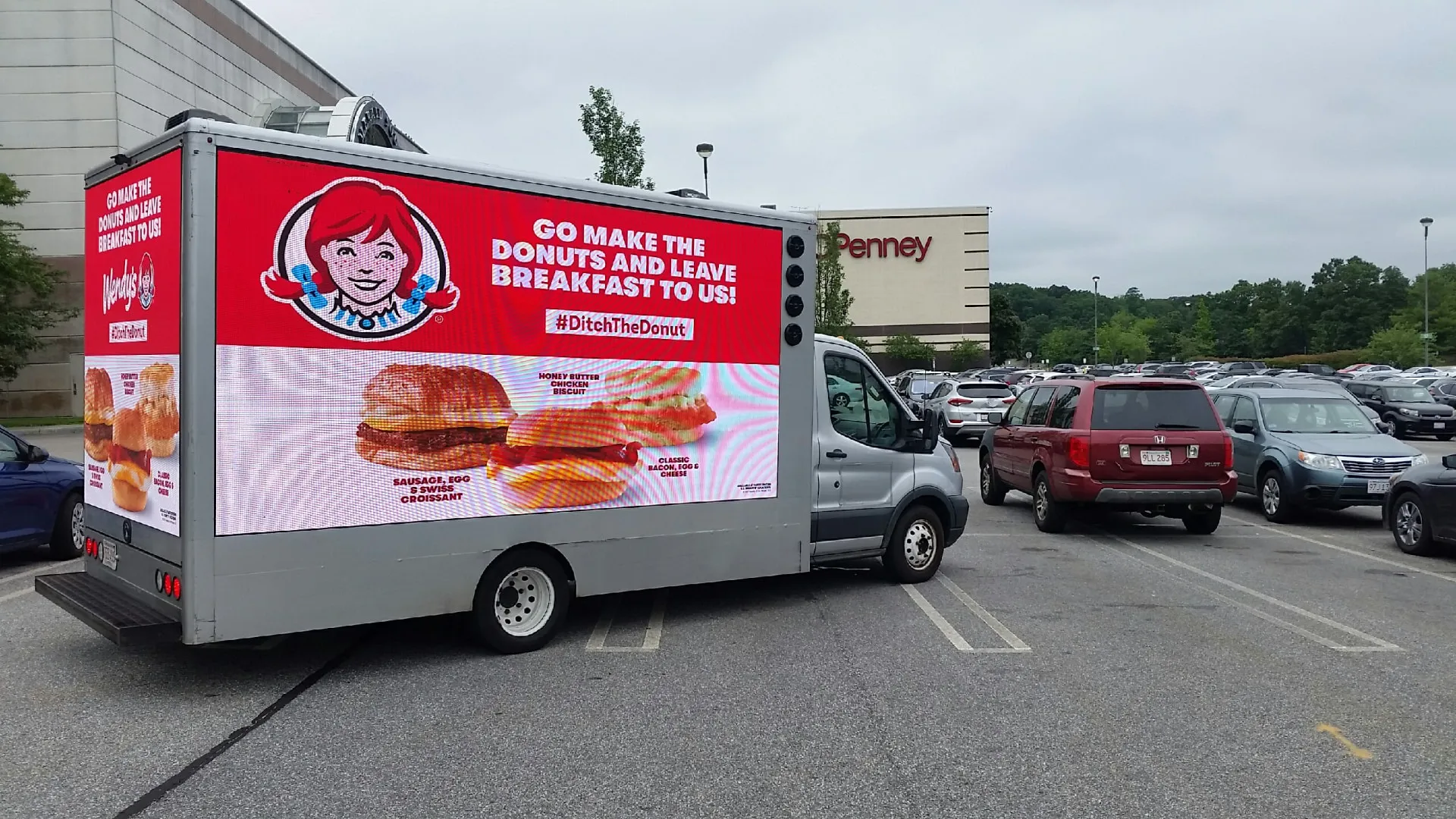 Wendy's #DitchTheDonut LED billboard truck in a mall parking lot near a JCPenney store